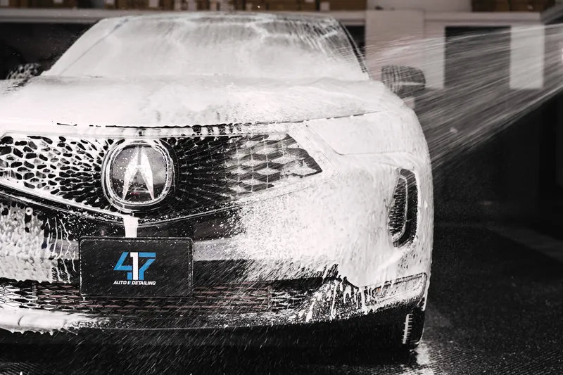Snow foam clinging to a freshly washed grille
