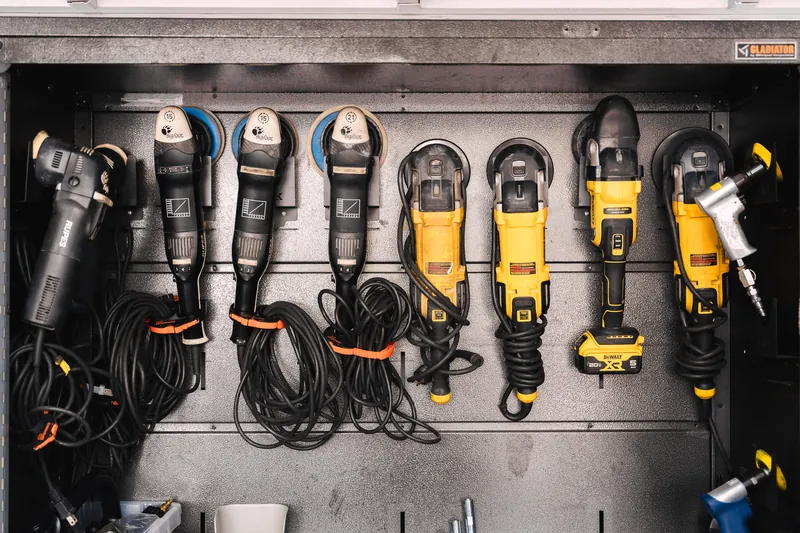 A wall of dual-action polishers at 417 Autoworks