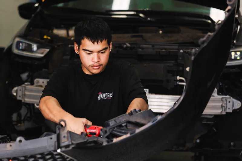 A technician reinstalling components after a repair