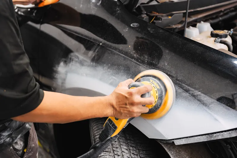 Machine-sanding to level a repaired surface for paint
