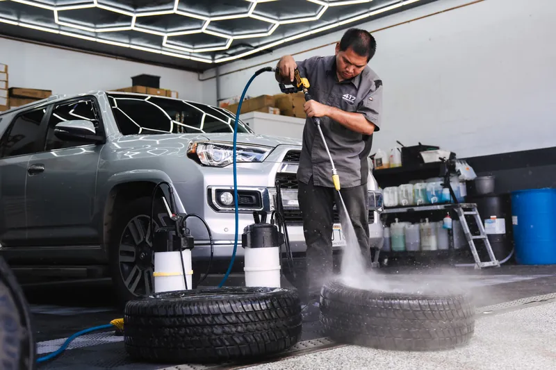 Rinsing wheels and tires in the detail bay