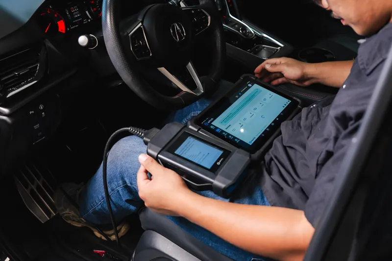 Running a diagnostic scan to recalibrate ADAS sensors on a customer vehicle at 417 Autoworks