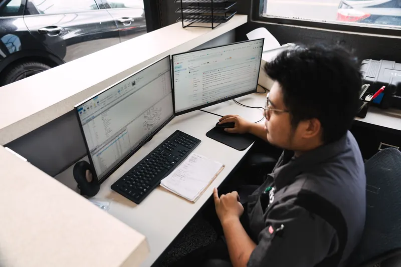 A 417 Autoworks estimator writing up a repair at the computer