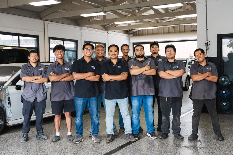 The full 417 Autoworks team lined up inside the shop