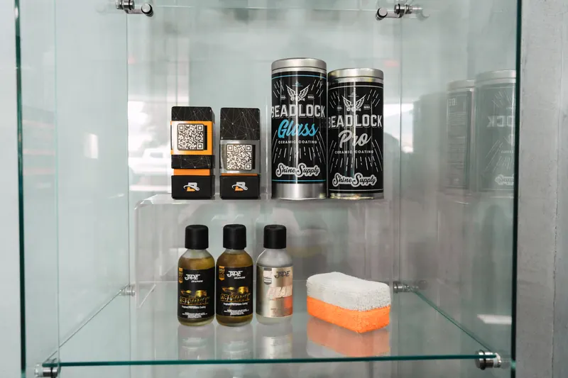 Ceramic coating products and applicators on the detailing shelf at 417 Autoworks